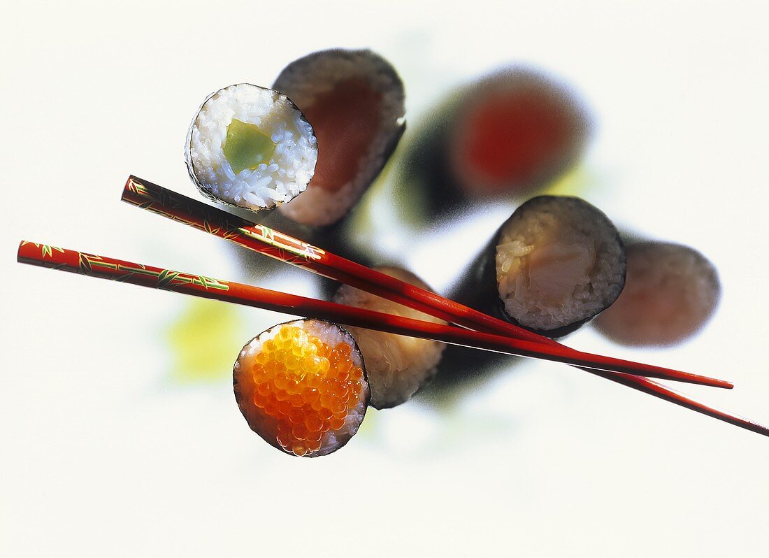 Sushi variations and red chopsticks