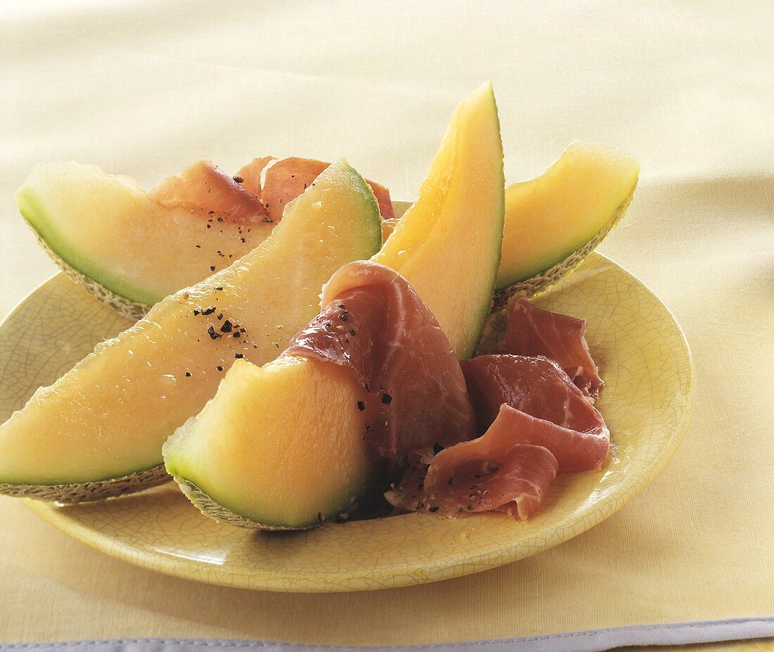 Slice of melon with ham and pepper