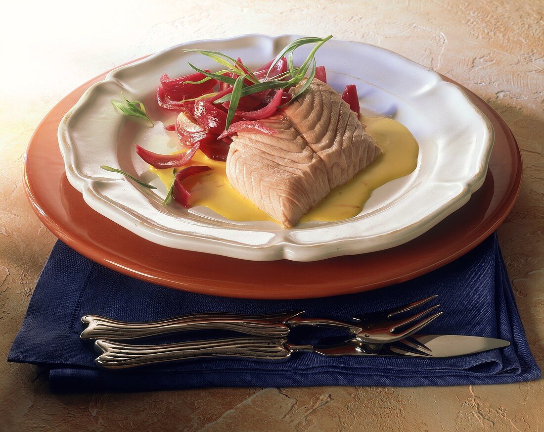 Salmon fillet with red onions and saffron cream sauce