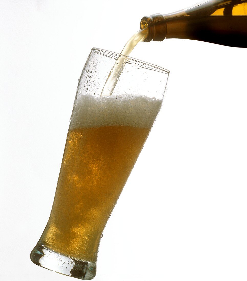 Pouring Weissbier from the bottle into a glass