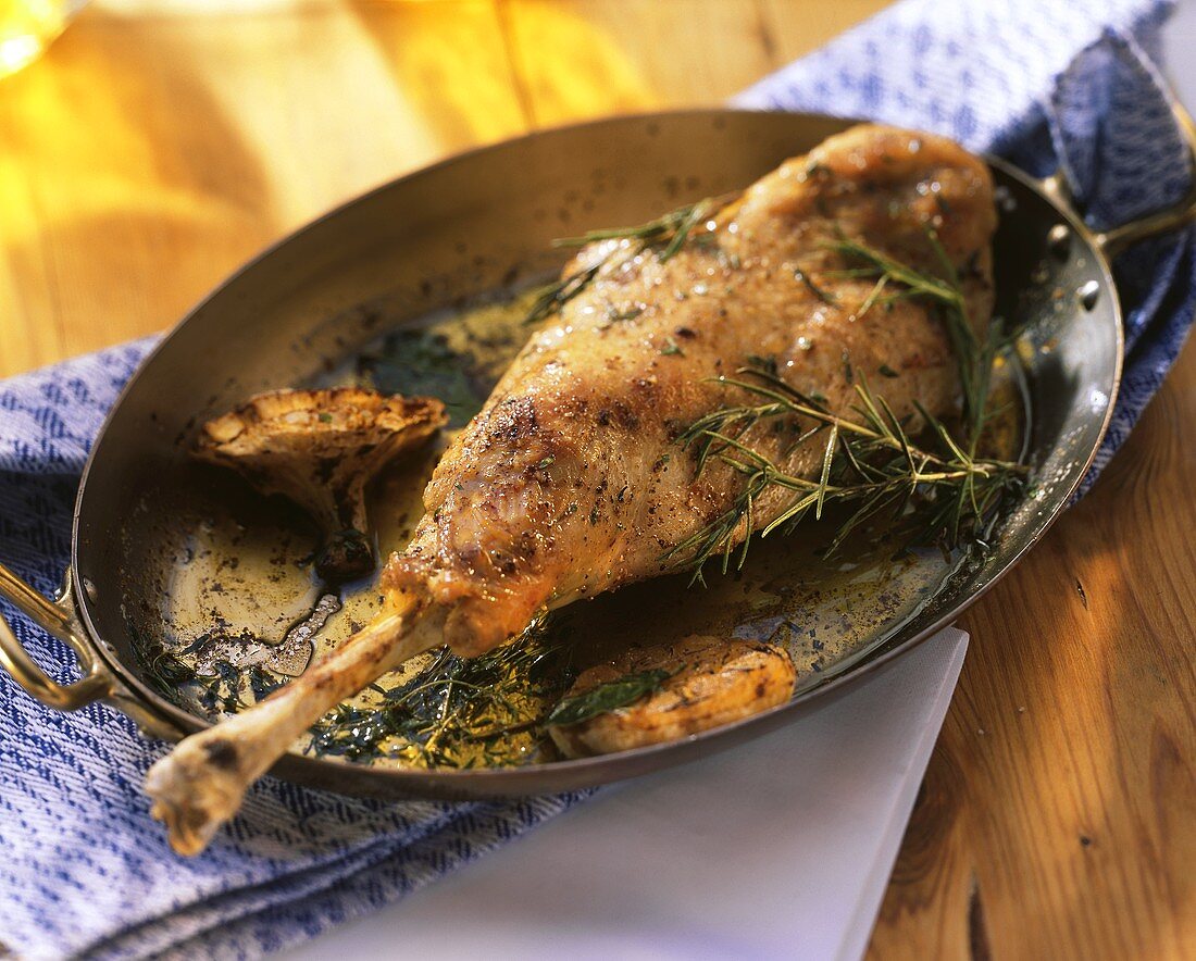 Braised leg of kid with garlic and herbs