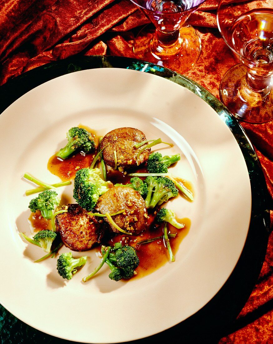 Pork fillets with peanut sauce and broccoli