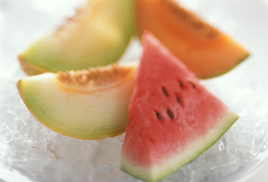 Various melon slices on crushed ice