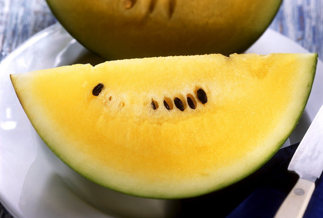 Slices of pineapple melon (yellow watermelon) on plate