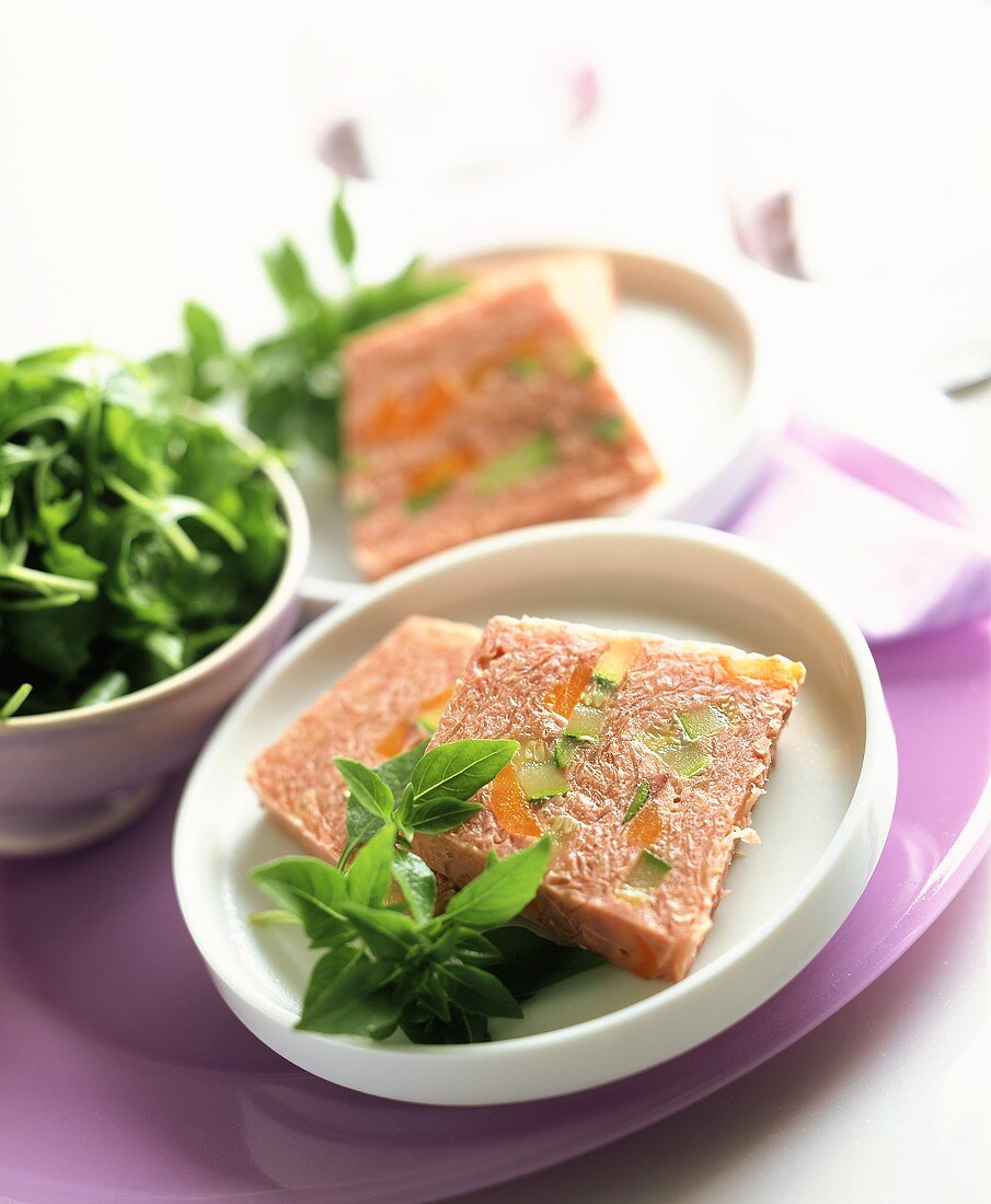 Two slices of red wine-cabbage terrine with vegetables