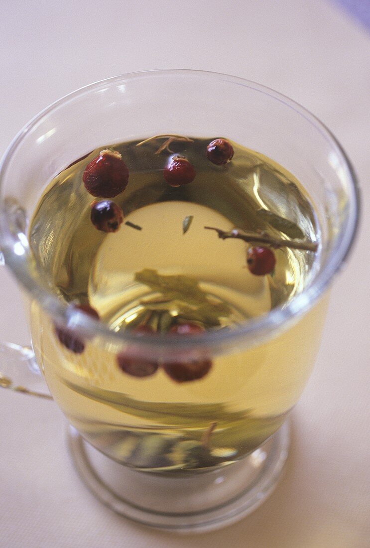 Herb tea with rose hips in glass