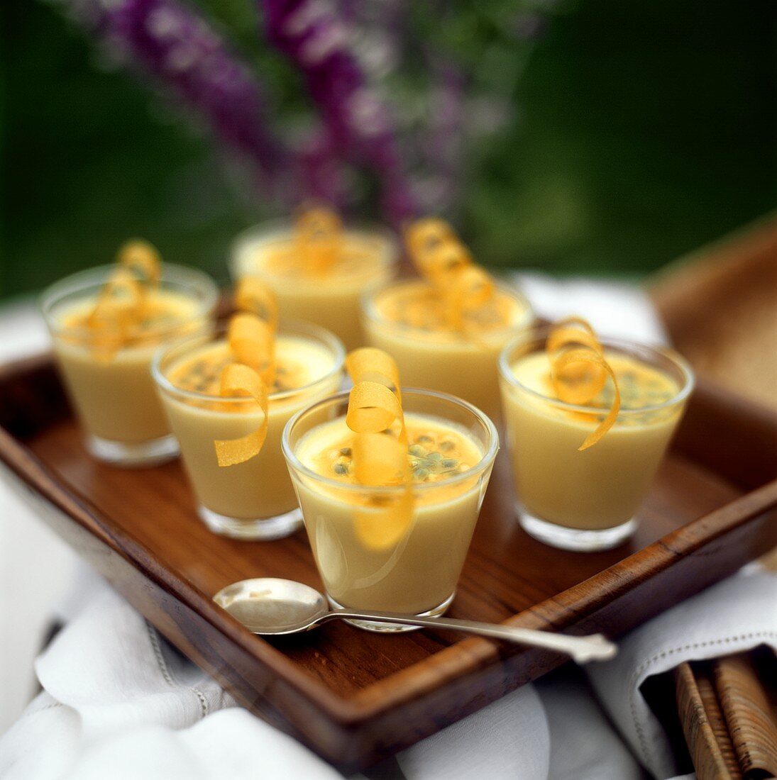 Passion fruit mousse in glasses on a tray