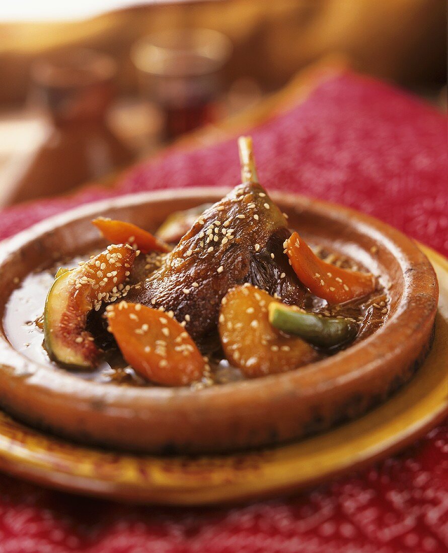 Duck confit tajine with figs, apricots and sesame