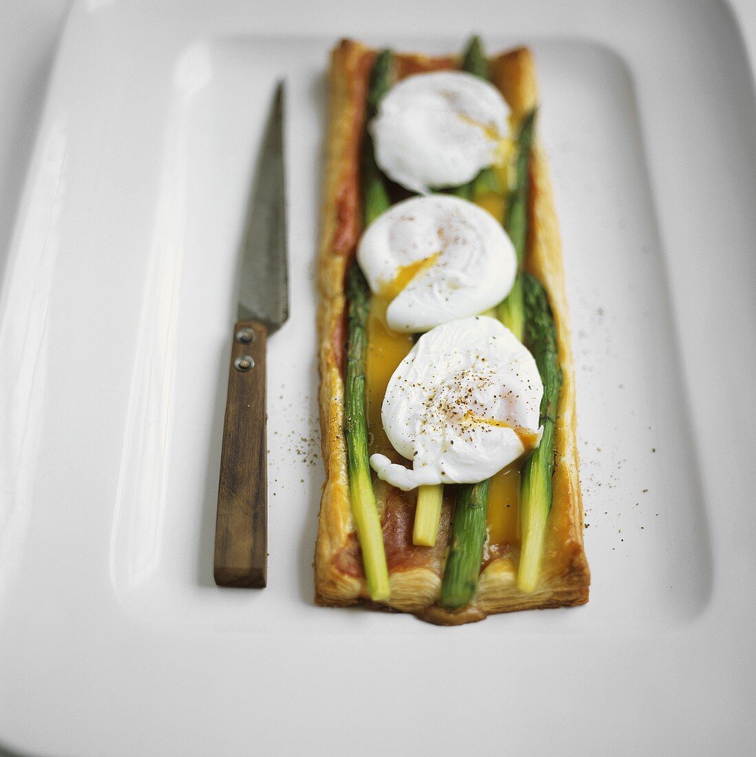 Savoury puff pastry quiche with asparagus and poached eggs