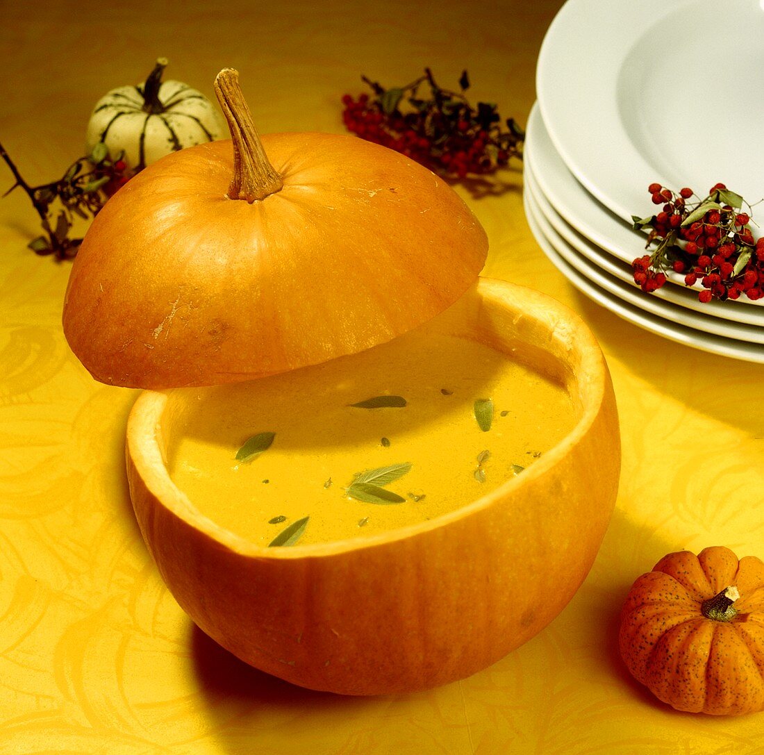 Pumpkin soup with sage, served in pumpkin