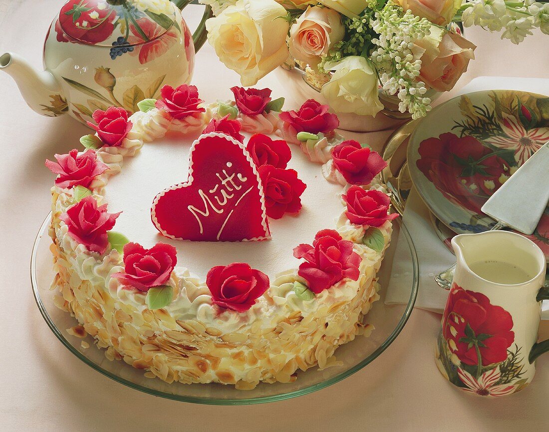White Mother's Day cake with red marzipan rose