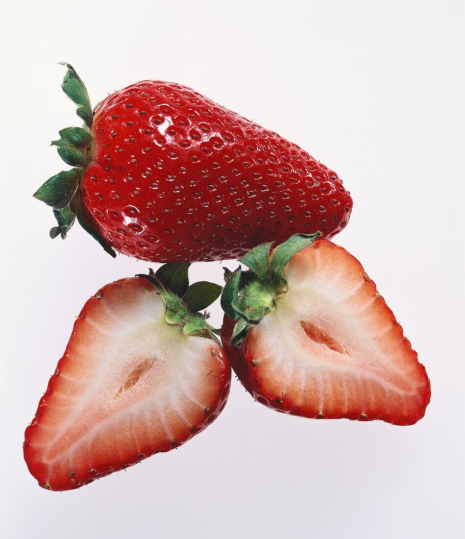 A whole and a cut strawberry
