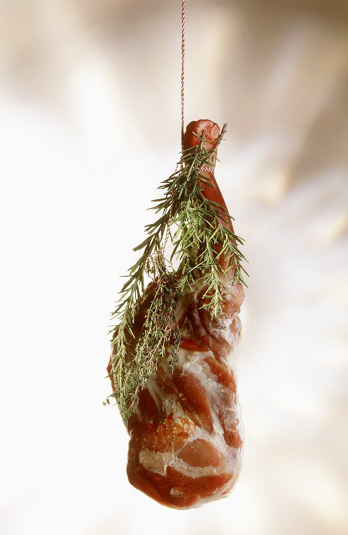 A leg of lamb with rosemary sprigs