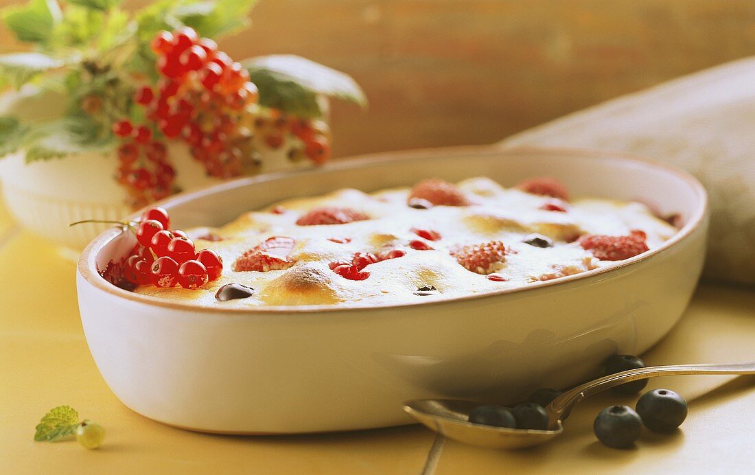 Cottage cheese gratin with colourful berries in dish