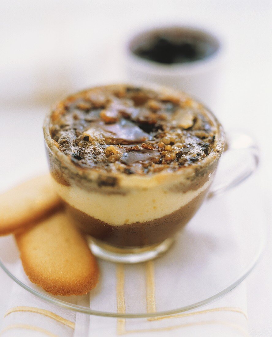 Light and dark chocolate mousse with caramel in a glass cup