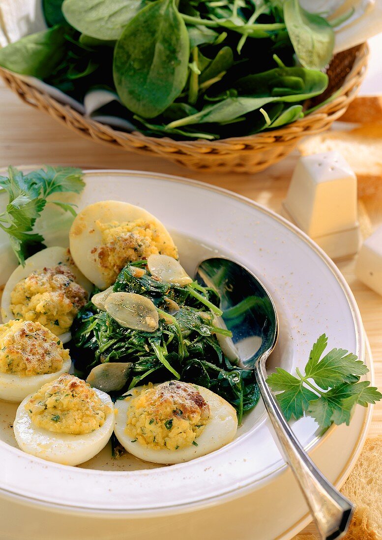 Baked stuffed eggs with spinach