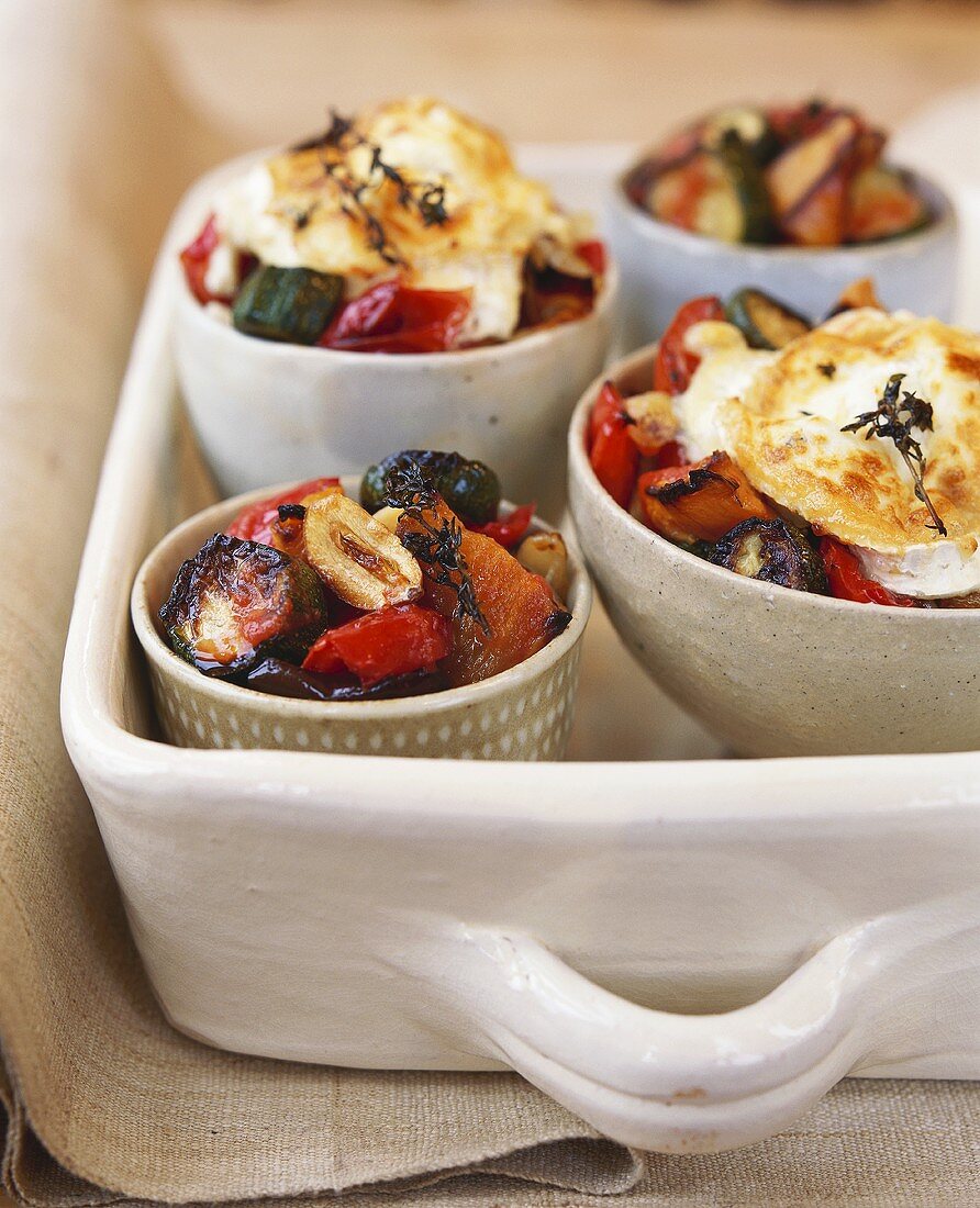 Roasted vegetables in bowl with toasted goat's cheese