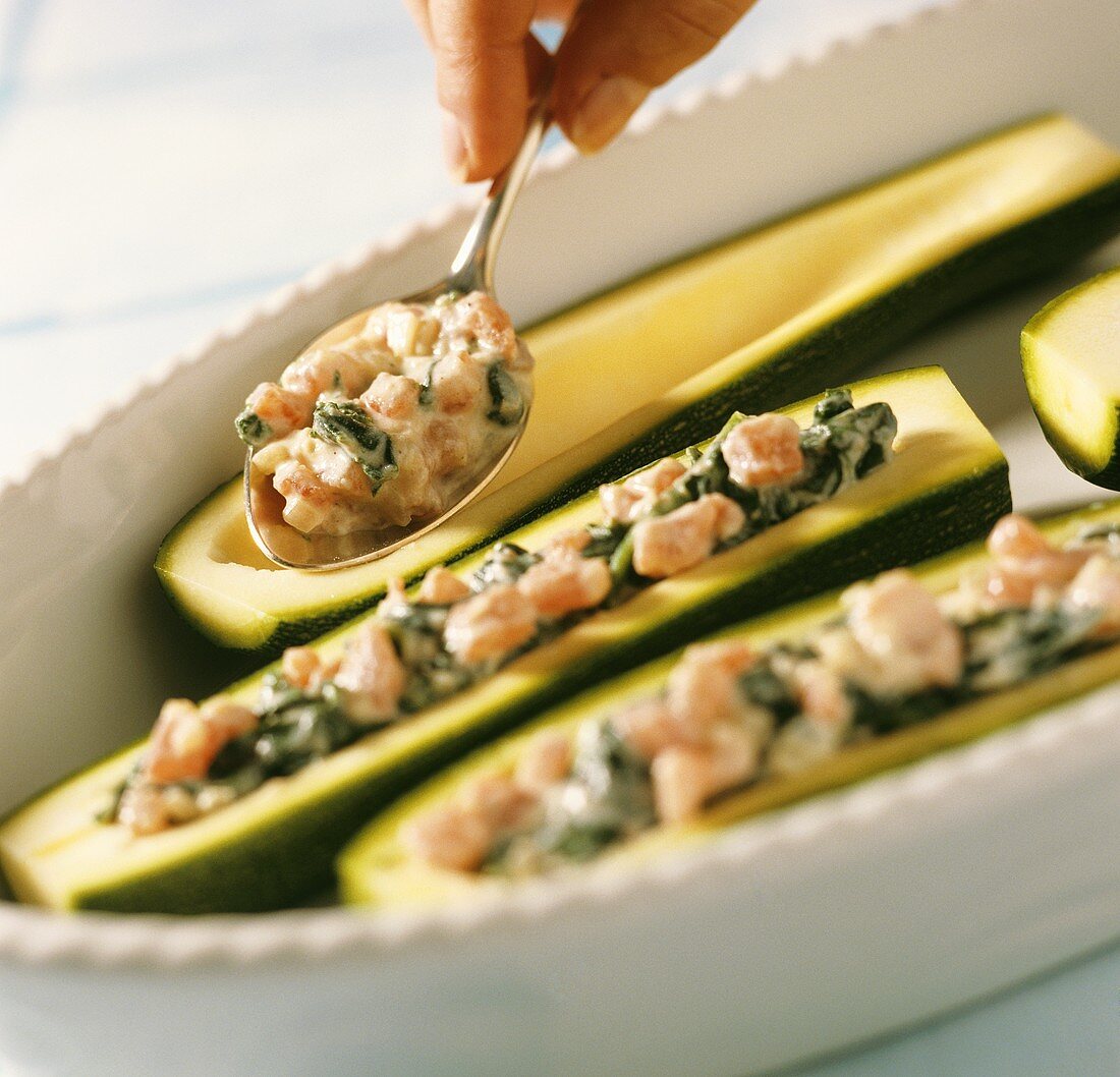 Preparing baked courgettes with cheese & spinach stuffing