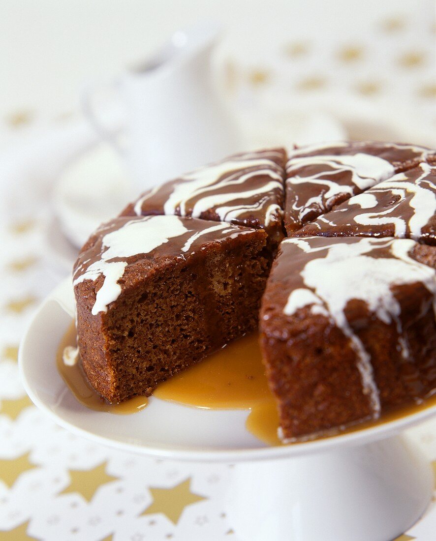 Chocolate cake, pieces cut on cake plate, with syrup