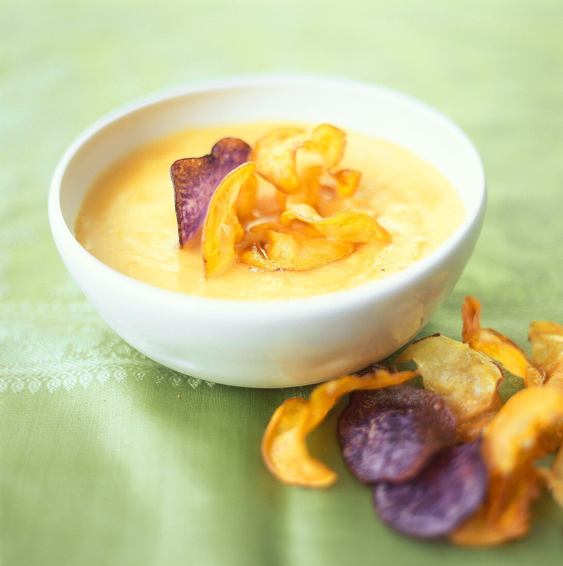 Potato and pumpkin soup with fried vegetable crisps