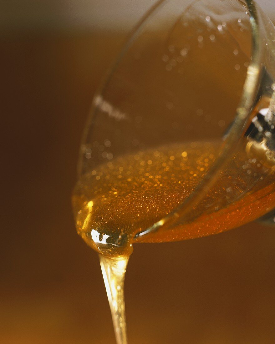 Honey running out of glass bowl