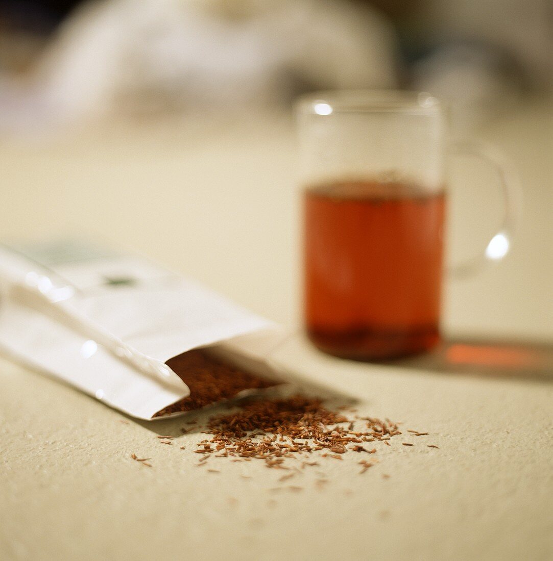 Rooibos tea in tea glass, behind in pack