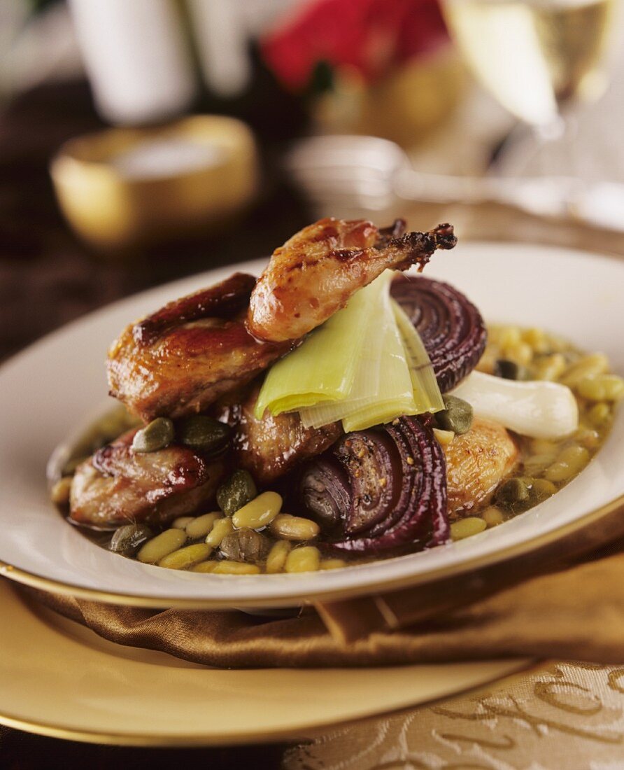 Quails on vegetables (beans, capers and onions)