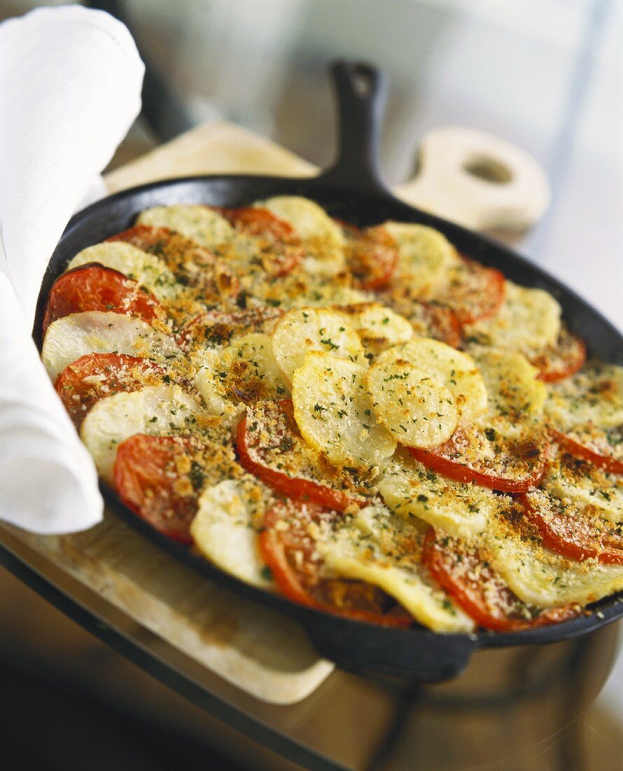 Pan-cooked potato and tomato dish with rosemary