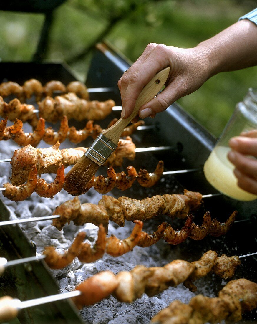 Chicken and shrimp kebabs on a grill