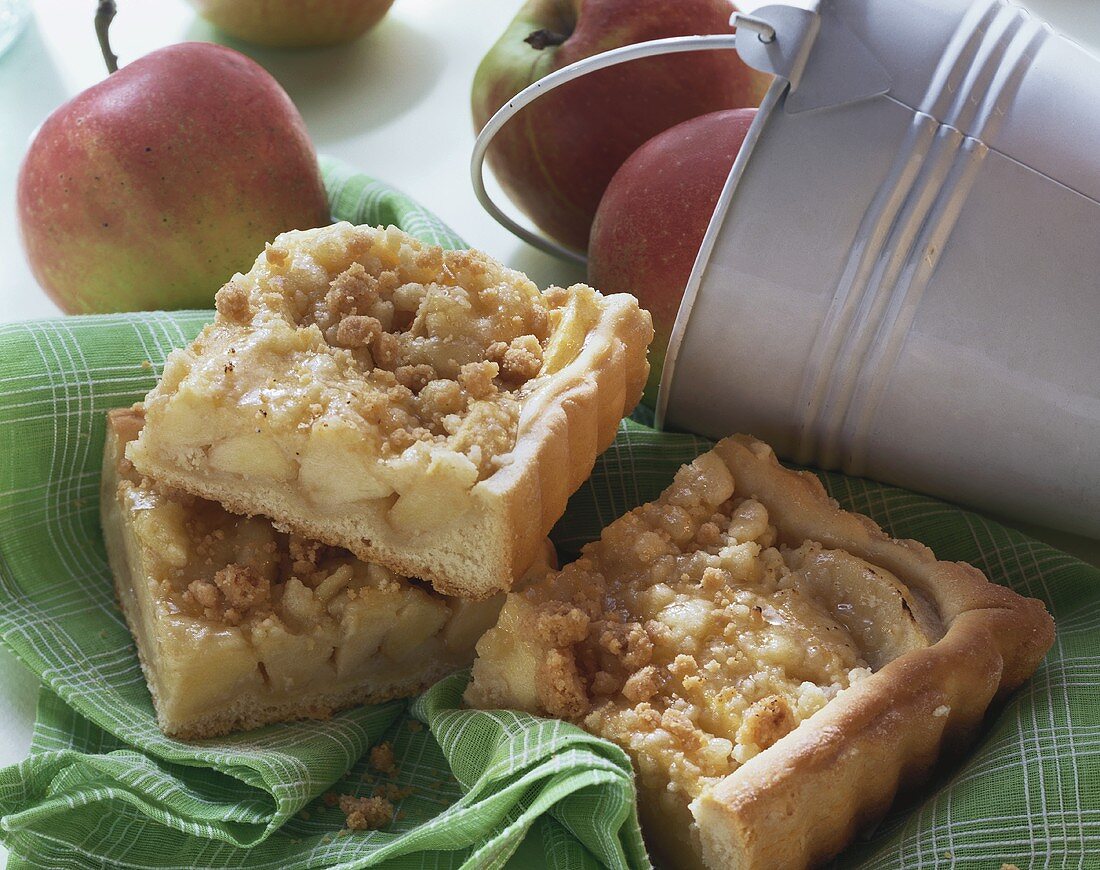 Several pieces of apple cake with crumble