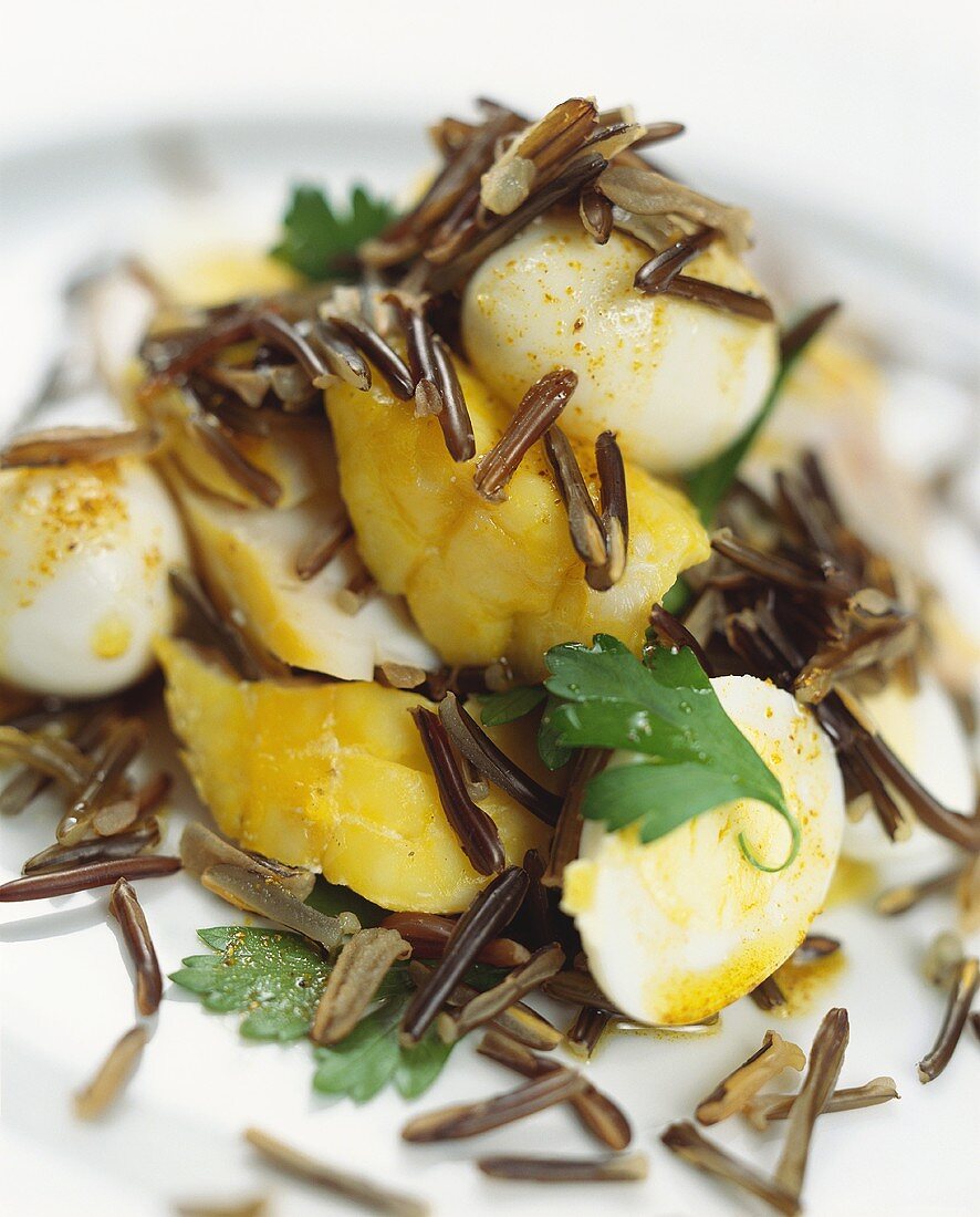 Saffron cod and quail's eggs on wild rice