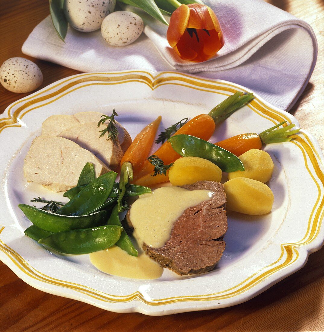 Poultry and meat platter with vegetables and lemon sauce