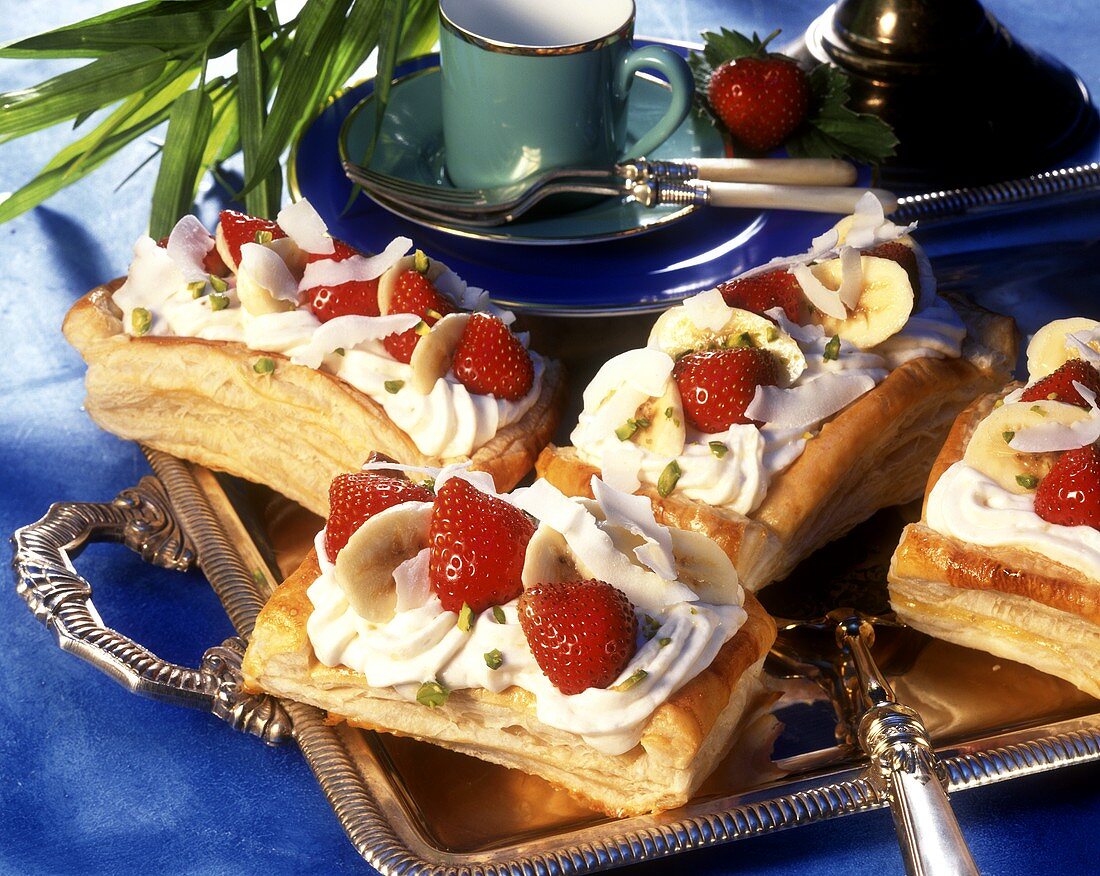 Banana and strawberries slices on puff pastry base