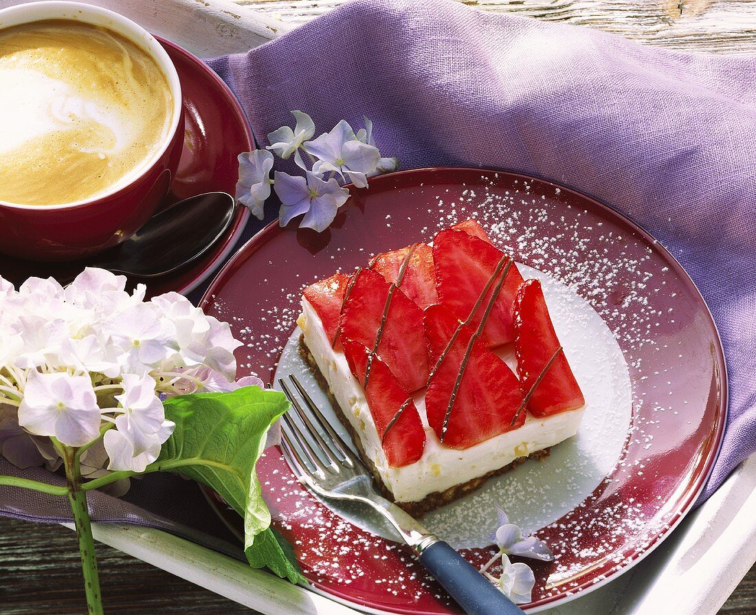 A piece of quark slice with strawberries on a plate