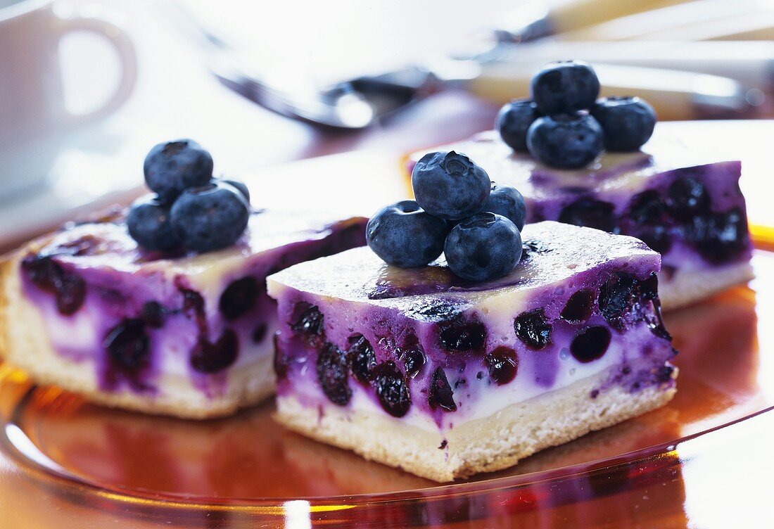 Several pieces of blueberry sour cream cake