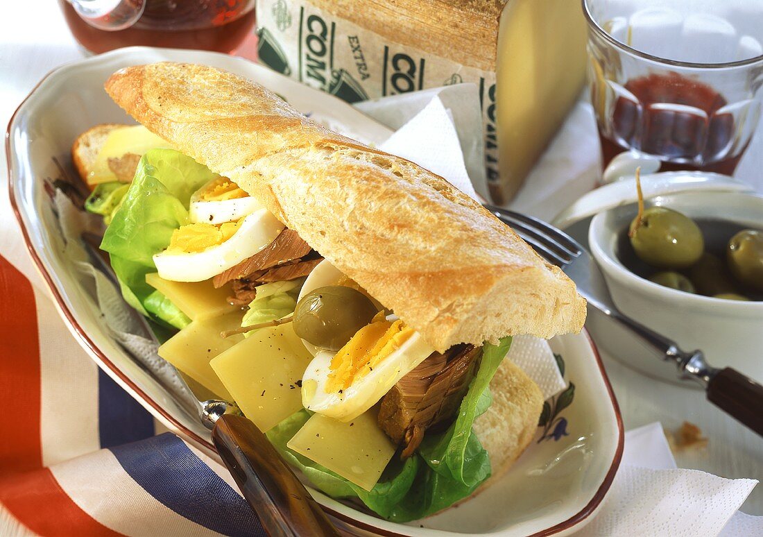 Baguette with cheese, tuna, egg, olives and lettuce