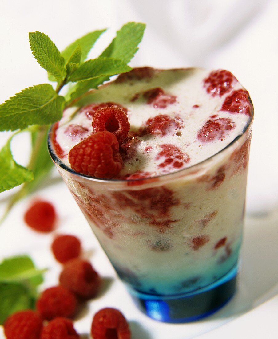 Milk shake with raspberries in a glass