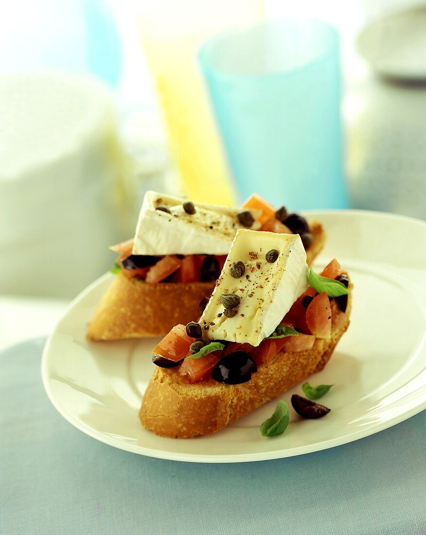 Bruschetta with tomatoes, basil, capers, brie and olives