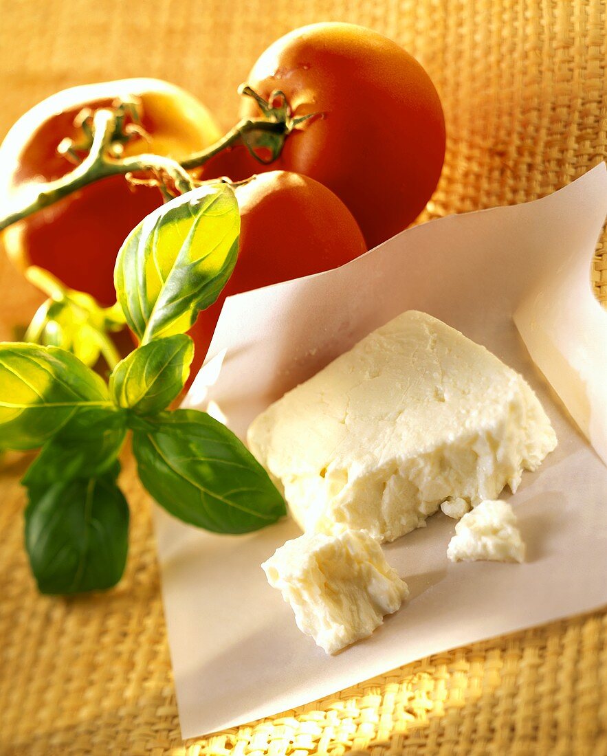 Sheep's cheese, tomatoes and basil beside it