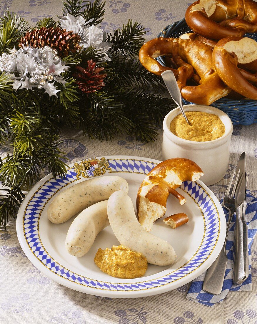 Plate with white sausages, pretzel and sweet mustard