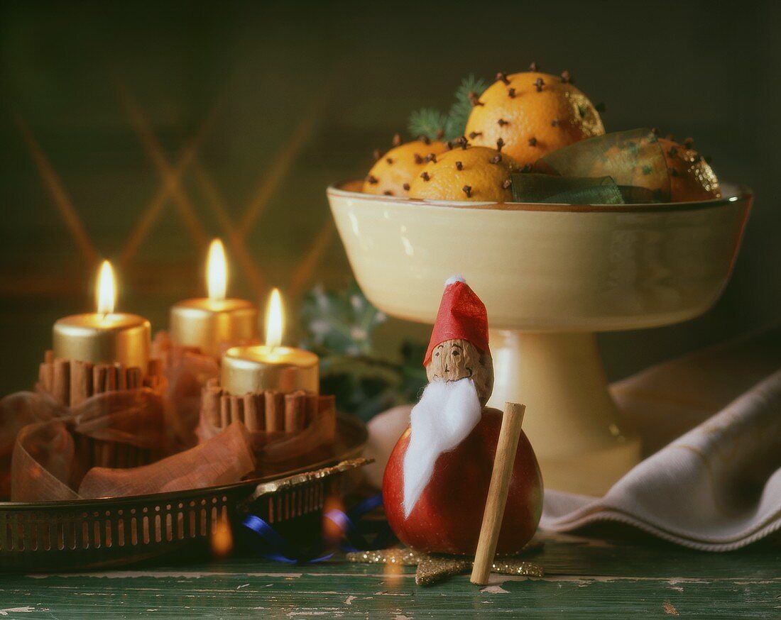 Clove-studded oranges, Father Christmas & burning candles