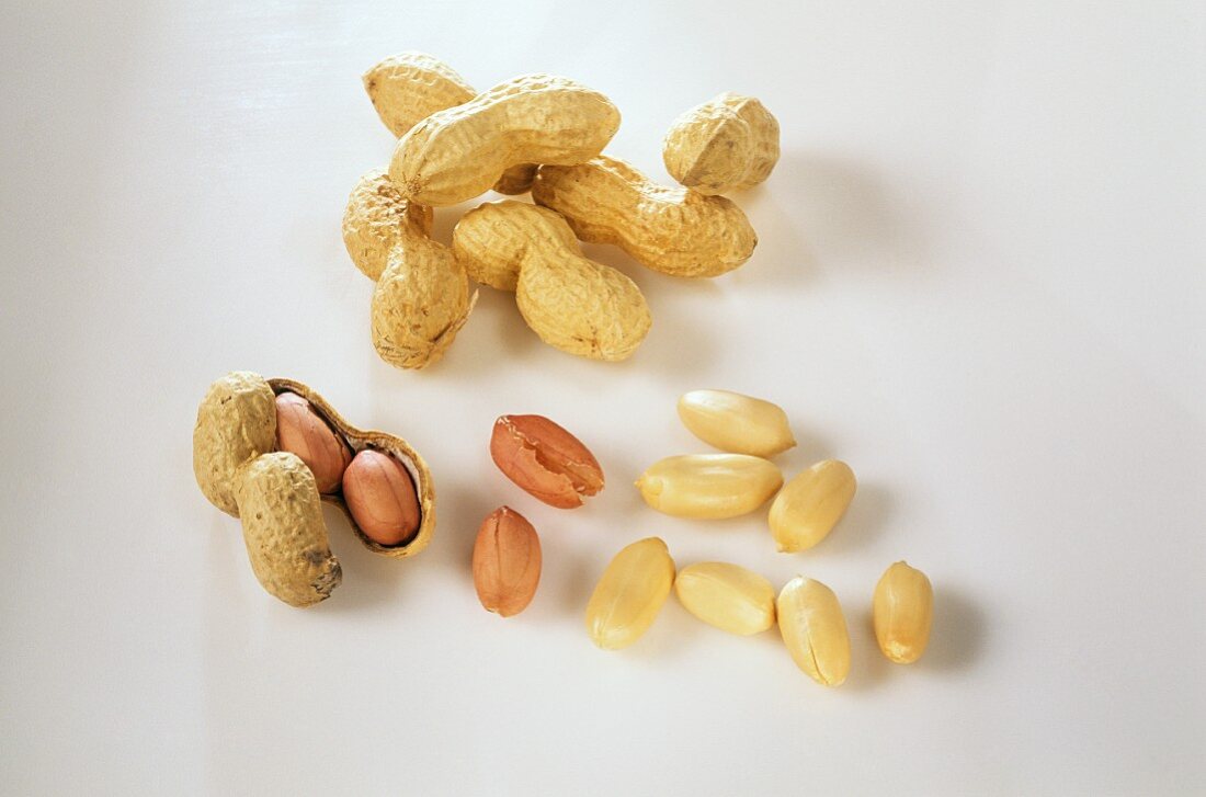 Several opened and unopened peanuts