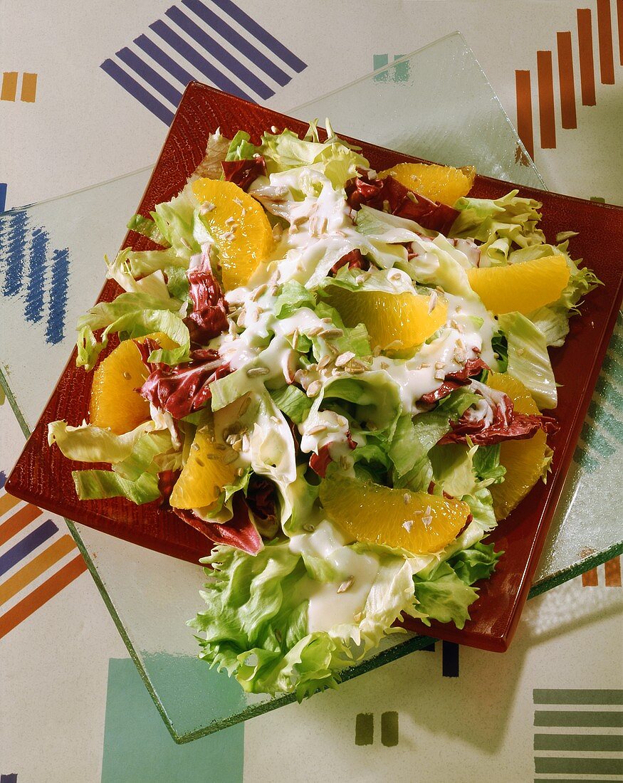 Mixed salad with sunflower seeds and orange segments