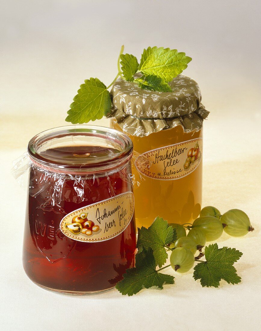 Gooseberry jelly and redcurrant jelly in jam jars