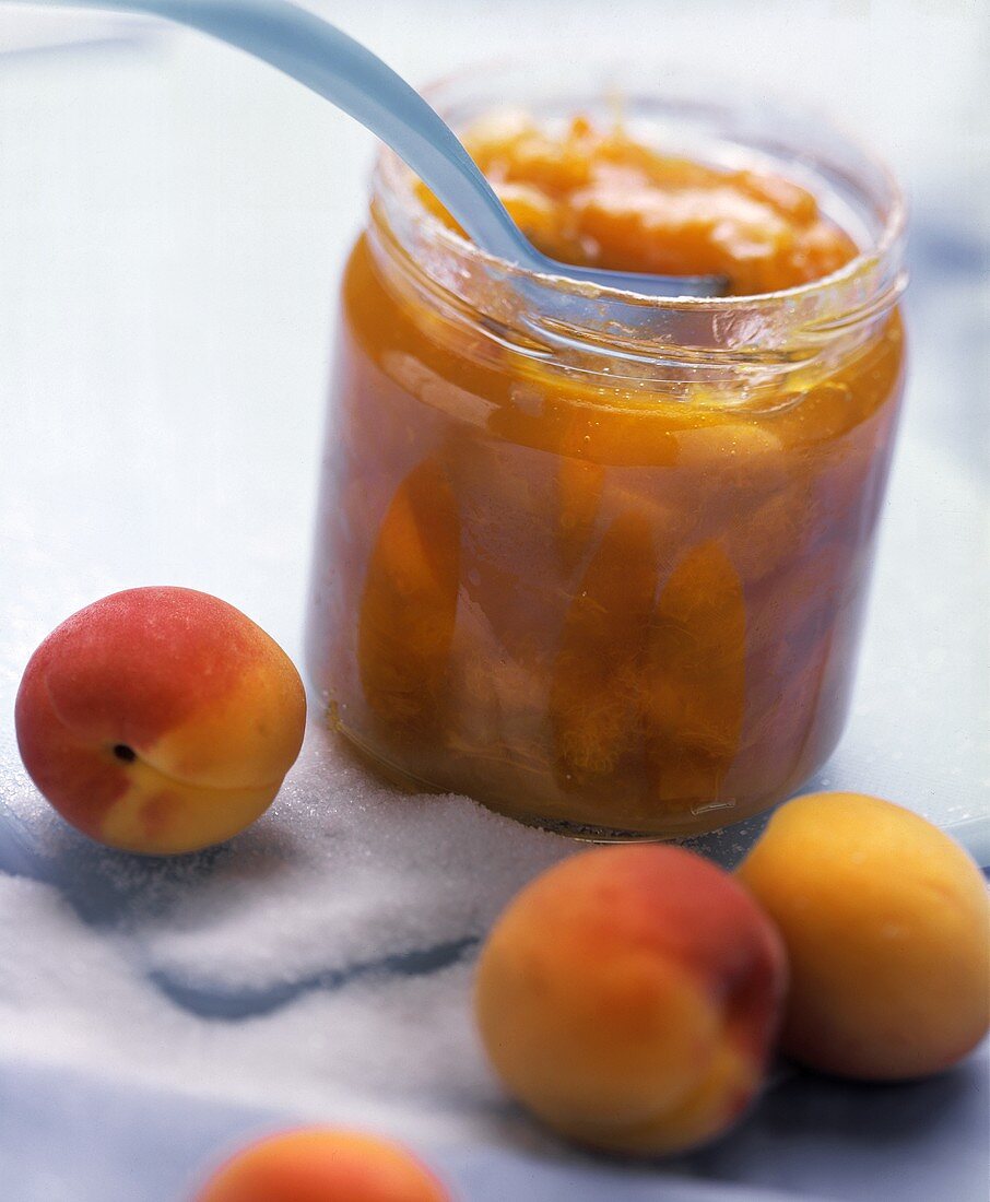 Apricot jam in a jar, decoration: peaches and sugar