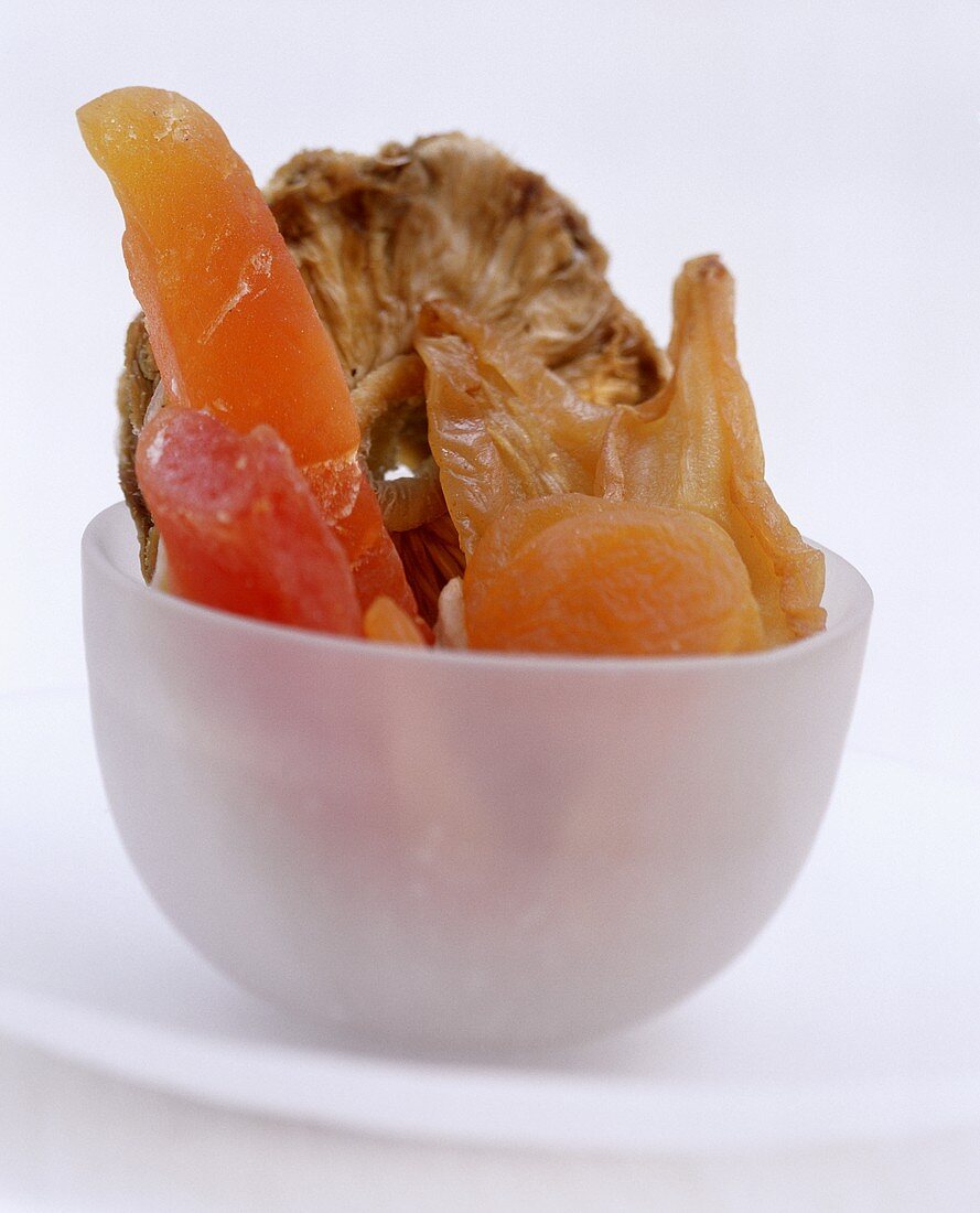 Various dried fruits in white bowls