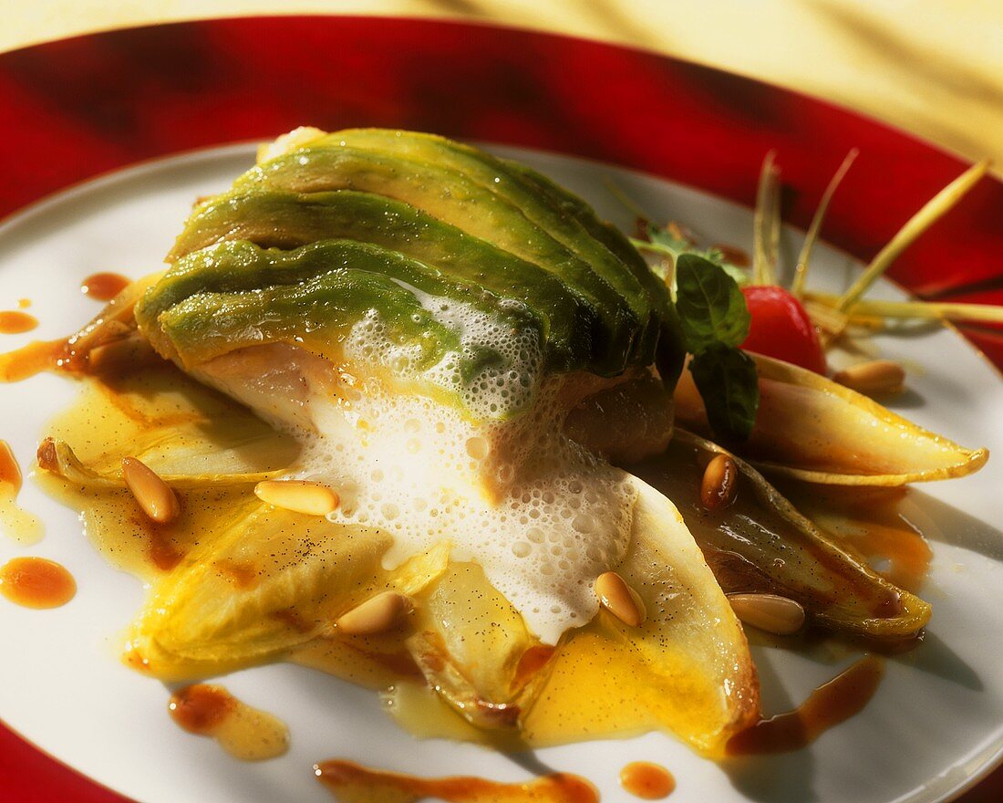 Fish fillet with avocado on chicory leaves