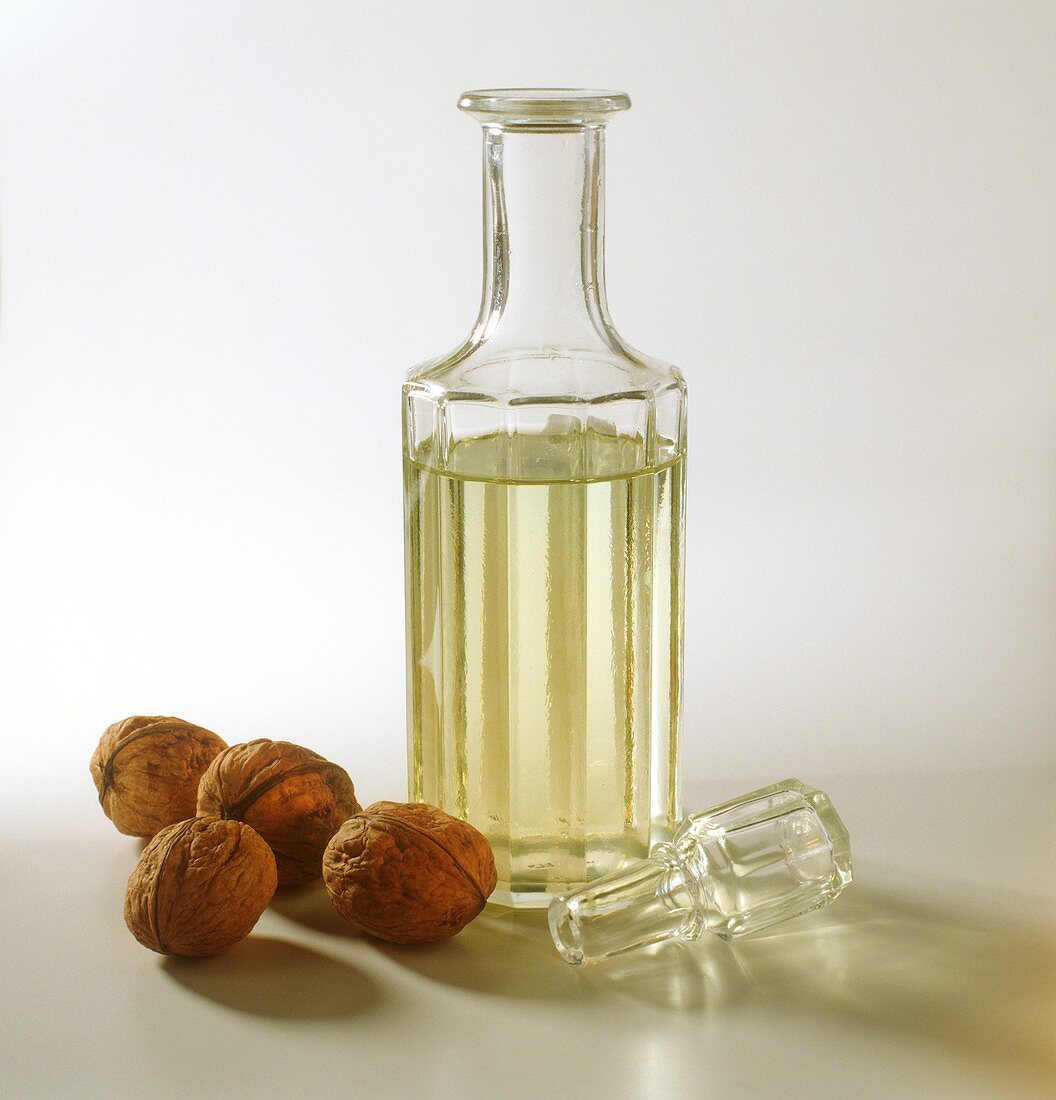 Walnut oil in decorative bottle, decoration: walnuts