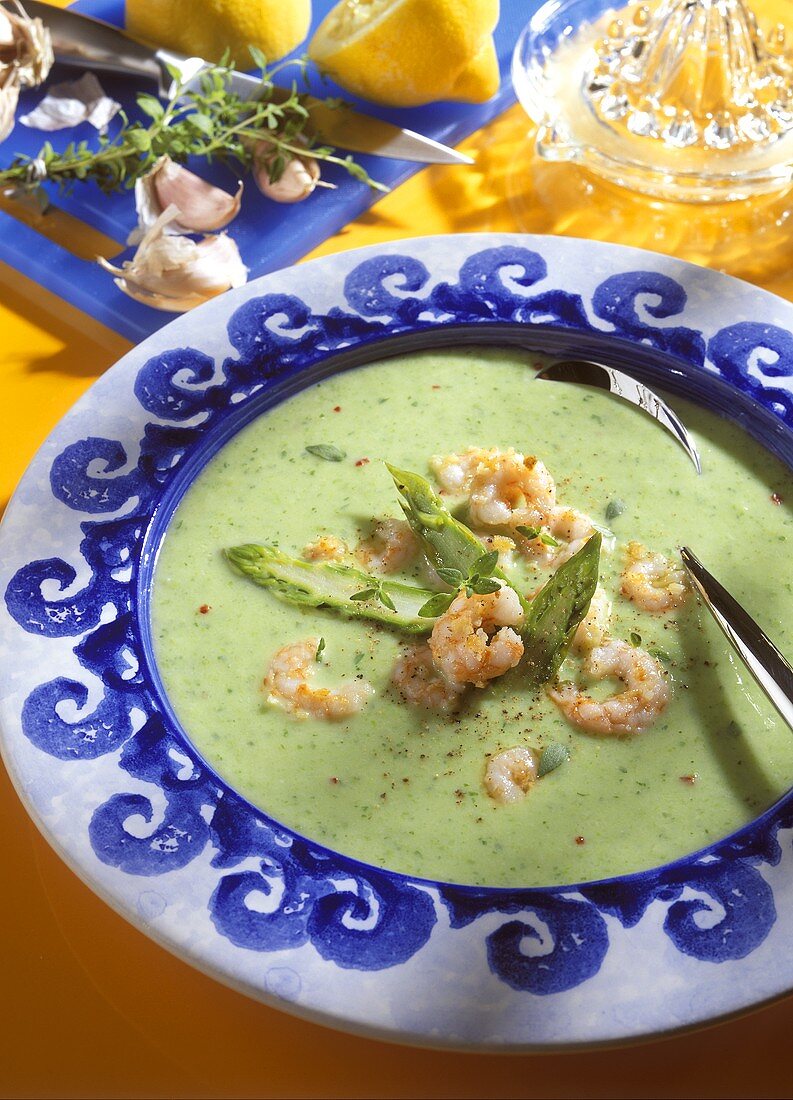 Green asparagus cream soup with shrimps