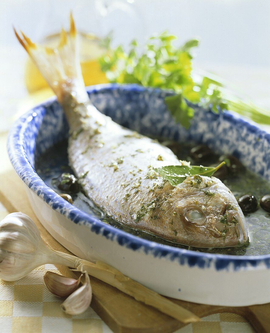 Bream with herbs with black olives and garlic